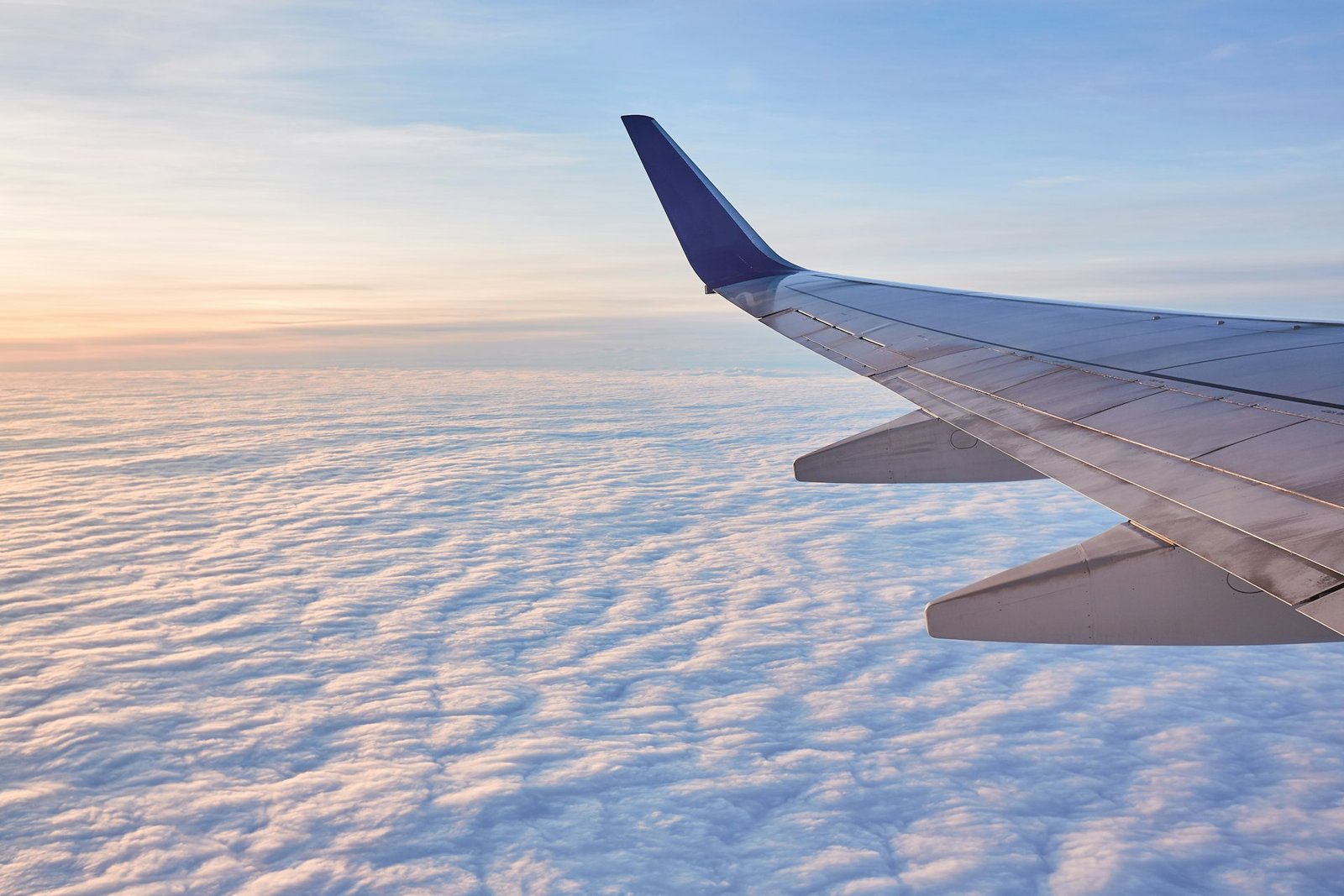 Aircraft wing above the clouds on an international flight