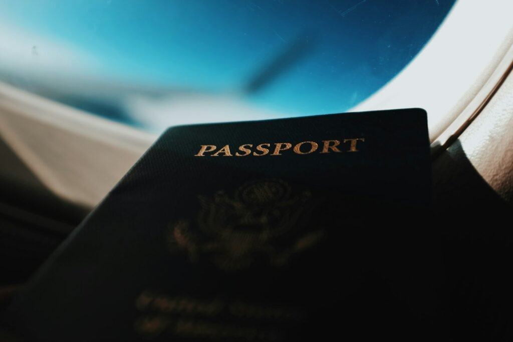 Passport held by an airplane window before an international flight